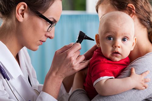 Doctor examining baby